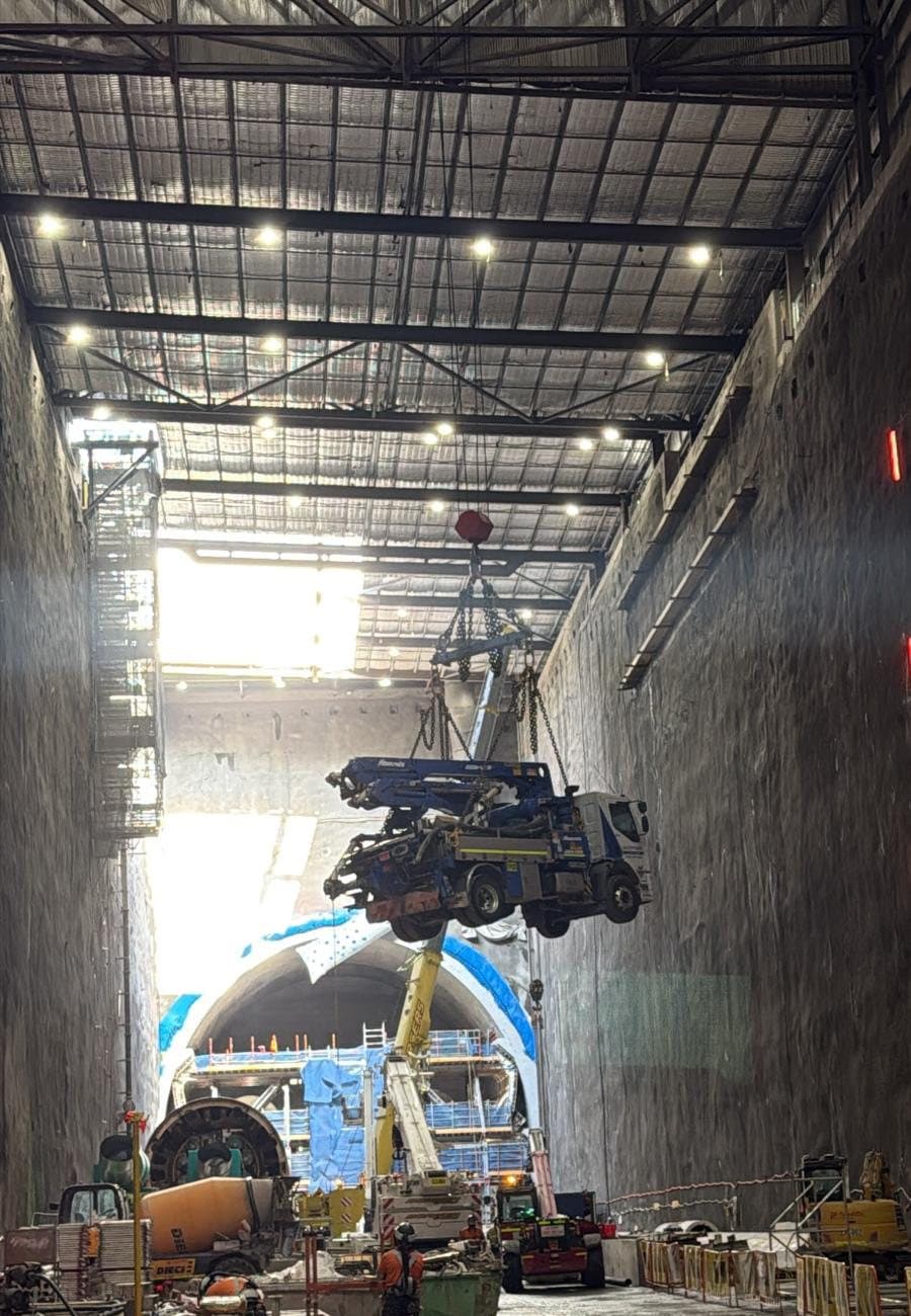 20m boom pump being lowered into a tunnel