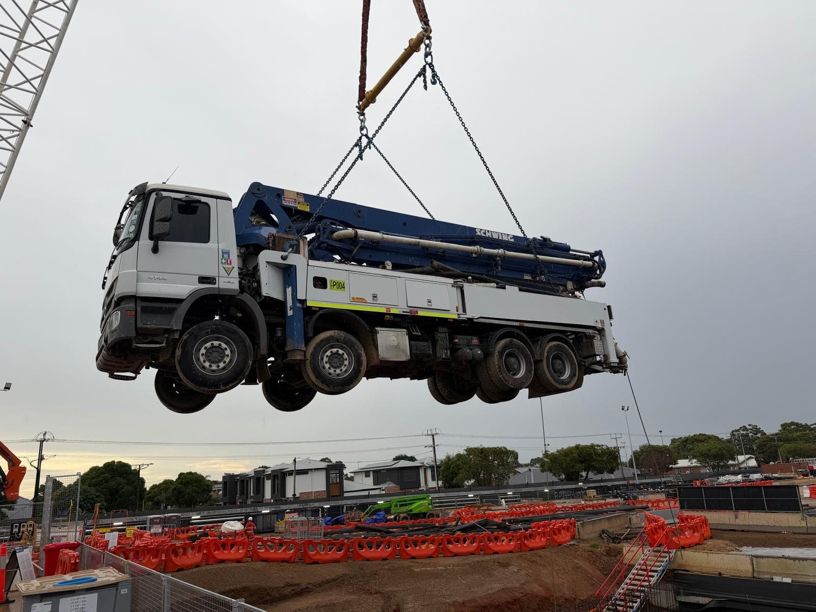 43m Schwing boom pump being craned into a site